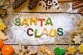 Biscuit letters and christmas decoration on wood, santa claus Royalty Free Stock Photo