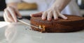 Biscuit. A young woman is preparing a biscuit for a festive cake. Festive cake decoration. Royalty Free Stock Photo