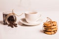 Biscuits with chocolate bandaged with canvas rope, are on white plastic background, with their reflection. Coffee beans Royalty Free Stock Photo