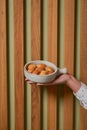 Biscuits with condensed milk in a white plate, closeup. Waiter serves nut cookies with condensed milk. Eating out