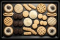 biscuits and cookies baking tray on large baking sheet Royalty Free Stock Photo