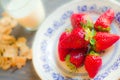 Biscuits, cornflakes, strawberry and milk