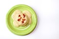 Biscuits and Gravy on a Green Plate isolated on a white background