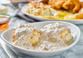 Biscuits and gravy with sausage on plate