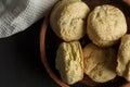 Biscuits made with buttermilk - scones in earthenware plate close up on black background