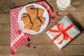 Biscuits, milk and gifts on a red napkin