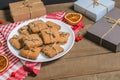 Biscuits; milk and gifts on a red napkin in Christmas decor with free space