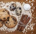 Biscuits, oats flakes, cinnamon sticks, meringue, eggs on a wood