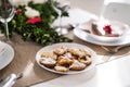 Biscuits on a table set for a dinner at home at Christmas time.