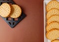 biscuits on white dish , round biscuits on brown background Royalty Free Stock Photo