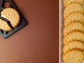 biscuits on white dish , round biscuits on brown background, close up Royalty Free Stock Photo