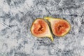 Bisected unripe fig fruit on textured background. Figs pulp. Top view