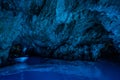 Bisevo, Croatia - Aug 16, 2020: Tourists on a boat in enter serene blue cave near Komiza island