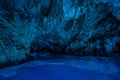 Bisevo, Croatia - Aug 16, 2020: Tourists on a boat in enter serene blue cave near Komiza island