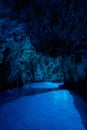 Bisevo, Croatia - Aug 16, 2020: Tourists on a boat in serene blue cave near Komiza island