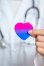 Bisexuality Celebrate Day and LGBT pride month, LGBTQ+ or LGBTQIA+ concept. Doctor holding purple, pink and blue heart shape for