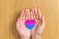 Bisexuality Celebrate Day and LGBT pride month, LGBTQ+ or LGBTQIA+ concept. Hand holding purple, pink and blue heart shape for