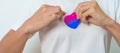 Bisexuality Celebrate Day and LGBT pride month, LGBTQ+ or LGBTQIA+ concept. Hand holding purple, pink and blue heart shape for