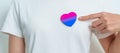 Bisexuality Celebrate Day and LGBT pride month, LGBTQ+ or LGBTQIA+ concept. Hand holding purple, pink and blue heart shape for