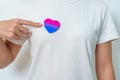 Bisexuality Celebrate Day and LGBT pride month, LGBTQ+ or LGBTQIA+ concept. Hand holding purple, pink and blue heart shape for