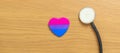 Bisexuality Celebrate Day and LGBT pride month, LGBTQ+ or LGBTQIA+ concept. Stethoscope with purple, pink and blue heart shape