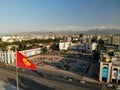 Bishkek Ala-Too square Aerial drone view. Big Kyrgystan flag. Flying over. Royalty Free Stock Photo