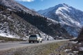 Bishkek, Kyrgyzstan - DEC 10, 2022: asphalt Road in Kyrgyzstan mountains with range rover car Royalty Free Stock Photo