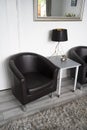 Bishop, Auckland, U.K. 27 July, 2021. Living room with two clasic black leather armchair and table with a lamp. Interior design,