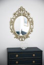 Bishop, Auckland, U.K. 27 July, 2021. Oval vintage mirror frame on the wall, bedroom furniture Royalty Free Stock Photo