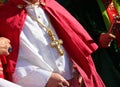 bishop wearing a cassock with the large Christian cross inlaid with precious gems during the religious ceremony