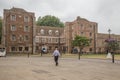 Bishops Palace in the centre of Ely with a man strolling Royalty Free Stock Photo