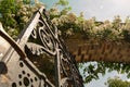 Bishops park, Fulham, London, detail. Brick arch, metal gate, white roses.