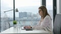 Bisinesswoman Sitting and Using a Laptop Indoors