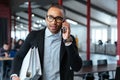 Bisnessman carrying folders and talking on the phone Royalty Free Stock Photo