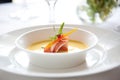 bisque in white bowl with lobster claw garnish Royalty Free Stock Photo