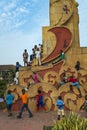 Children playing at a statue in the Praca dos Herois Nacionais, in Guinea-Bissau