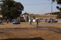 Street scene in the city of Bissau with people crossing the Amilcar Cabral Avenue, in Guinea-Bissau.
