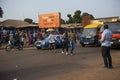 Street scene in the city of Bissau with people walking crossing a street near the Bandim Market, in Guinea-Bissau