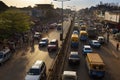 Street scene in the city of Bissau during rush hour with cars in an avenue and people at the Bandim Market, in Guinea-Bissau