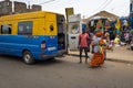 Street scene in the city of Bissau with people exiting a public bus Toca Toca at the Bandim Market, in Guinea-Bissau