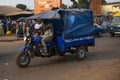 Man riding his motor tricycle in front of the Bandim Market, in Guinea-Bissau