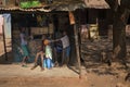 Young family in front of their small store in a slum of the city of Bissau