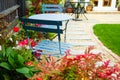 Bistro set at an end of the Summer garden, with autumnal reds