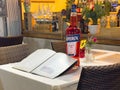Bistro table with aperol bottle, menu, and flower vase Royalty Free Stock Photo