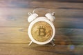 Bitcoin, alarm clock on the background