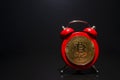 Bitcoin and alarm clock on black background. Deadline concept for investing in bitcoin cryptocurrency. Royalty Free Stock Photo