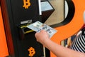 Bitcoin atm machine money. Usd hundred money payment on virtual crypto currency btc wallet. Woman withdraw american