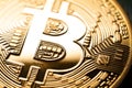 Bitcoin B logo. Macro photo of shiny gold coin symbol detail. Simple bright golden bitcoin crypto currency logo.