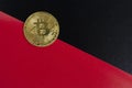 Bitcoin on the background of black and red sheets of paper stacked along the diagonal. The concept of falling value and Royalty Free Stock Photo