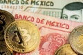 Bitcoin BTC Cryptocurrency coins and Mexican Pesos MXN currency banknotes. Royalty Free Stock Photo